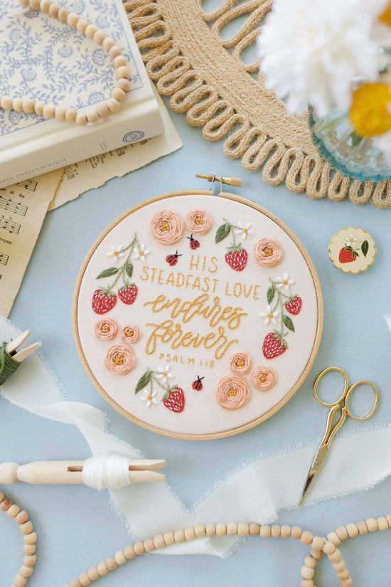Finished Psalm 118 'His steadfast love endures forever' hand embroidery design in a hoop