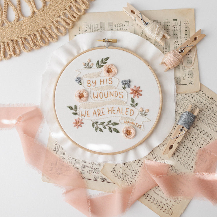 By His Wounds We Are Healed hoop on sheet music with blush ribbon