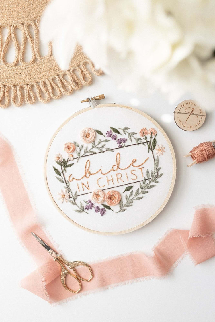 Abide in Christ embroidery hoop styled on jute with blush ribbon