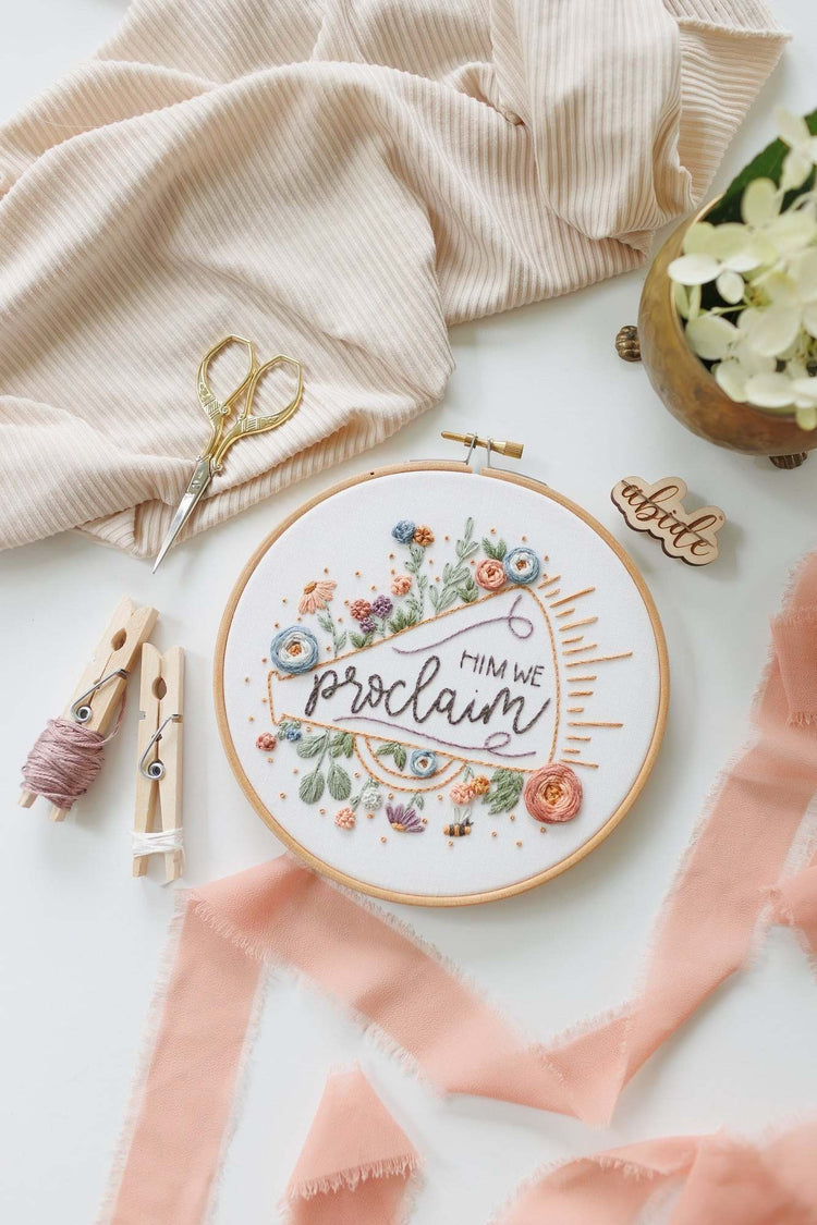 Him We Proclaim hoop styled with linen, brass and white florals