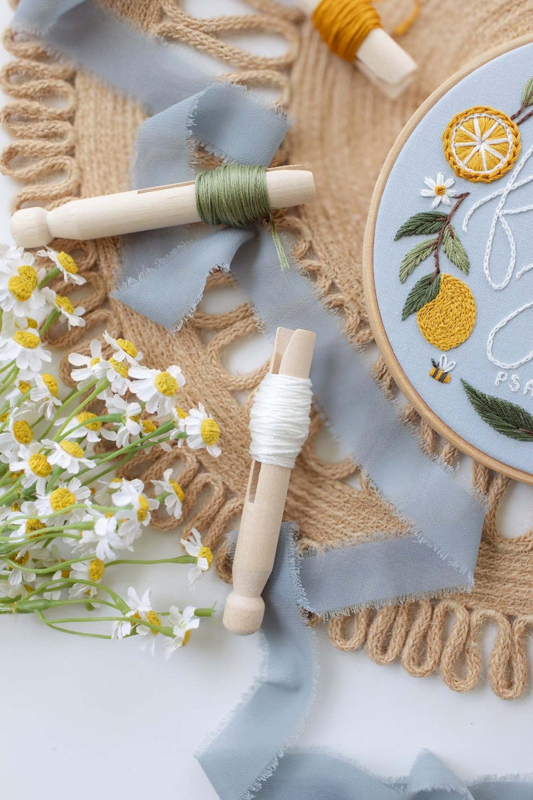 Close-up of the stitched lemons and daisies