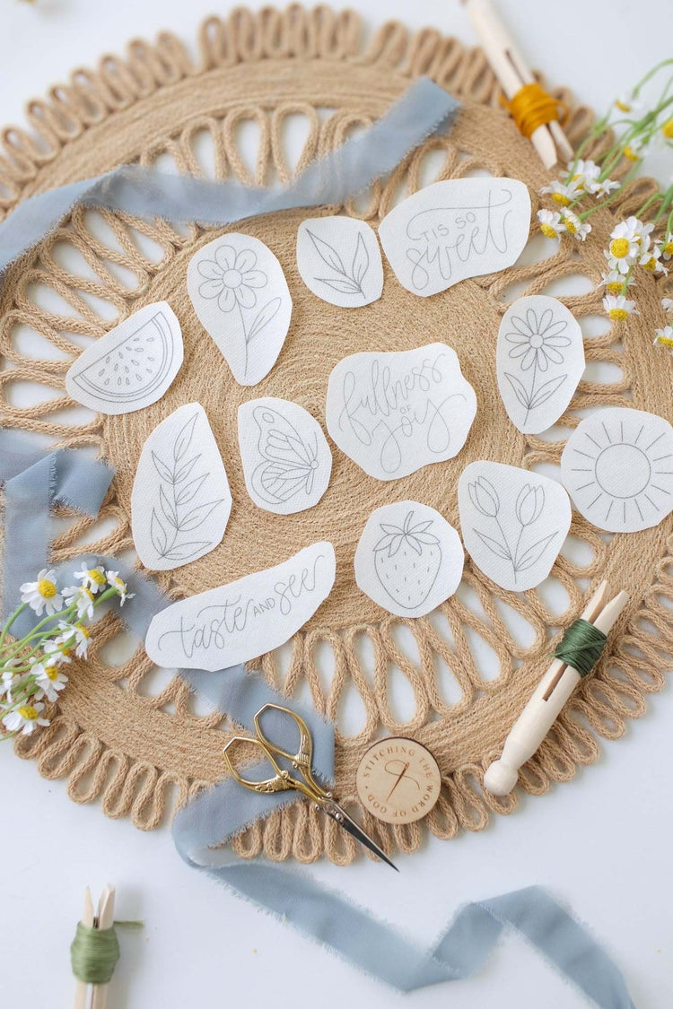 Taste and See stick and stitch designs laid out on a woven placemat