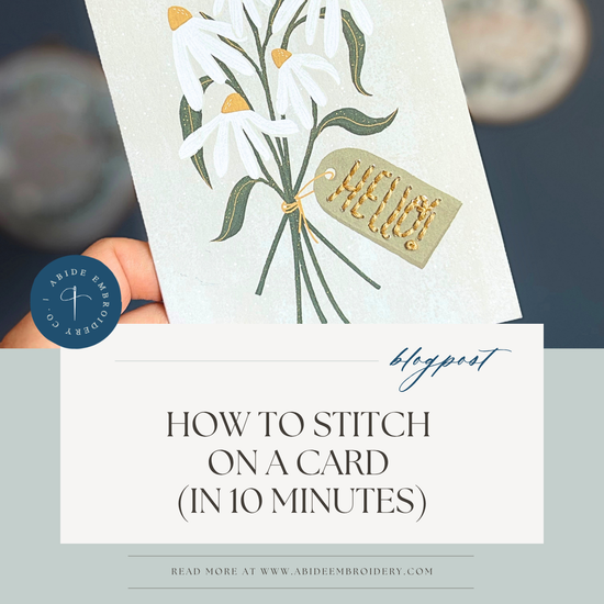 Hand-stitched lettering on a folded note card with embroidery floss