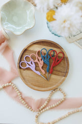 Stork embroidery scissors shown with an embroidery project — collectible bird-shaped scissors
