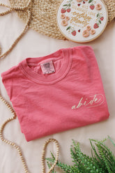 Back design of the His Steadfast Love Psalm 118 t-shirt — hand-lettered Scripture framed by florals, strawberries and needle-and-thread