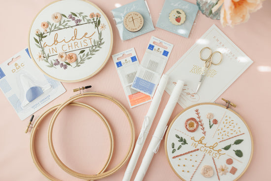 Everything in the Complete Embroidery Starter Kit laid out on a blush background