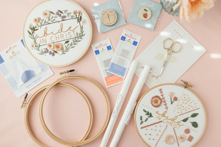 Everything in the Complete Embroidery Starter Kit laid out on a blush background