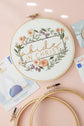 Abide in Christ embroidery hoop with a DMC needle threader and two extra 6-inch hoops