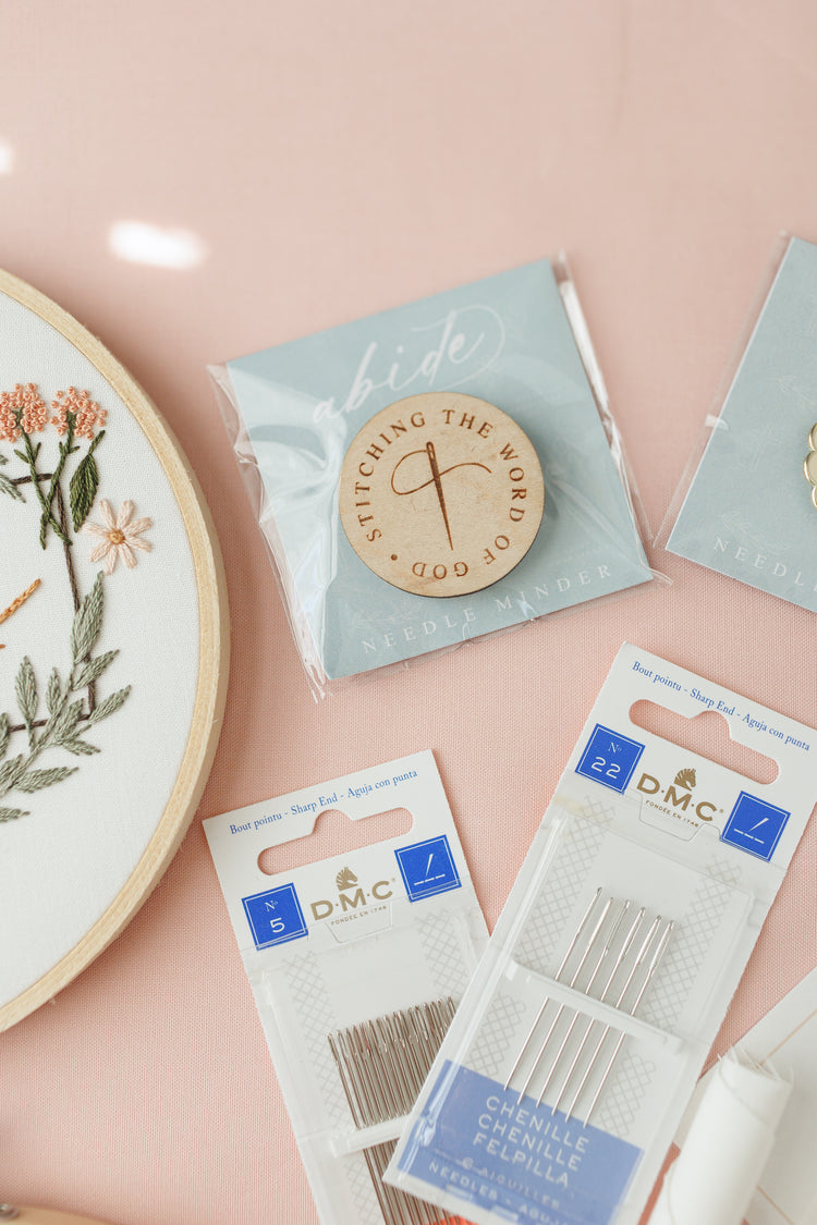 Stitching the Word of God wooden needle minder with DMC needle packs