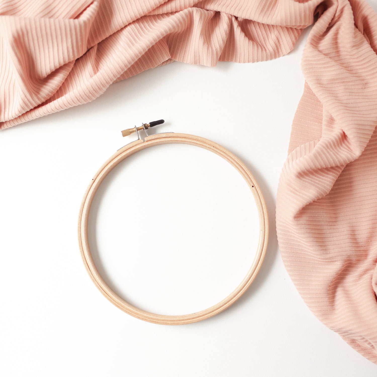 6 inch wooden embroidery hoop with brass tension screw, shown empty on a blush backdrop