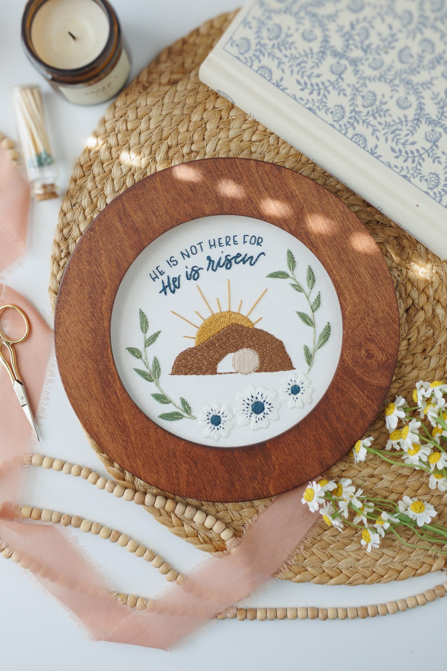 He Is Risen Easter embroidery hoop with a candle and daisies
