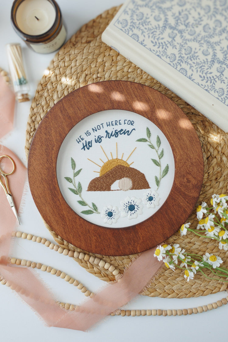 He Is Risen Easter embroidery hoop with a candle and daisies
