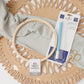 DMC embroidery transfer pen in packaging with a wooden hoop, fabric and gold scissors