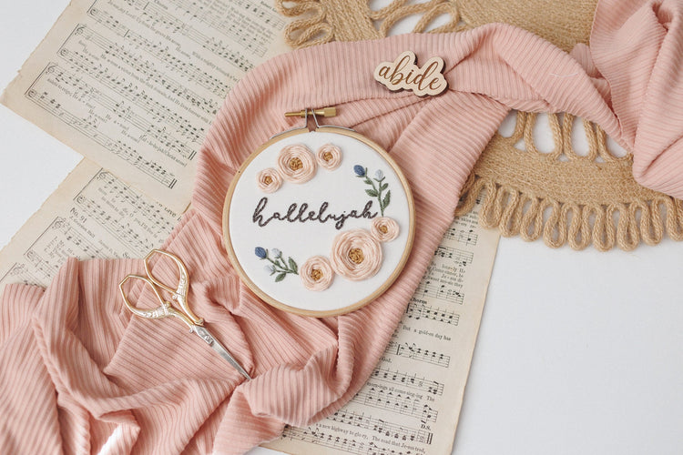 Hallelujah hoop styled on vintage sheet music with a blush drape