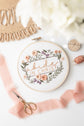 Abide in Christ embroidery hoop styled on jute with blush ribbon