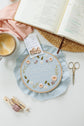 Psalm 103 embroidery hoop beside an open Bible and coffee