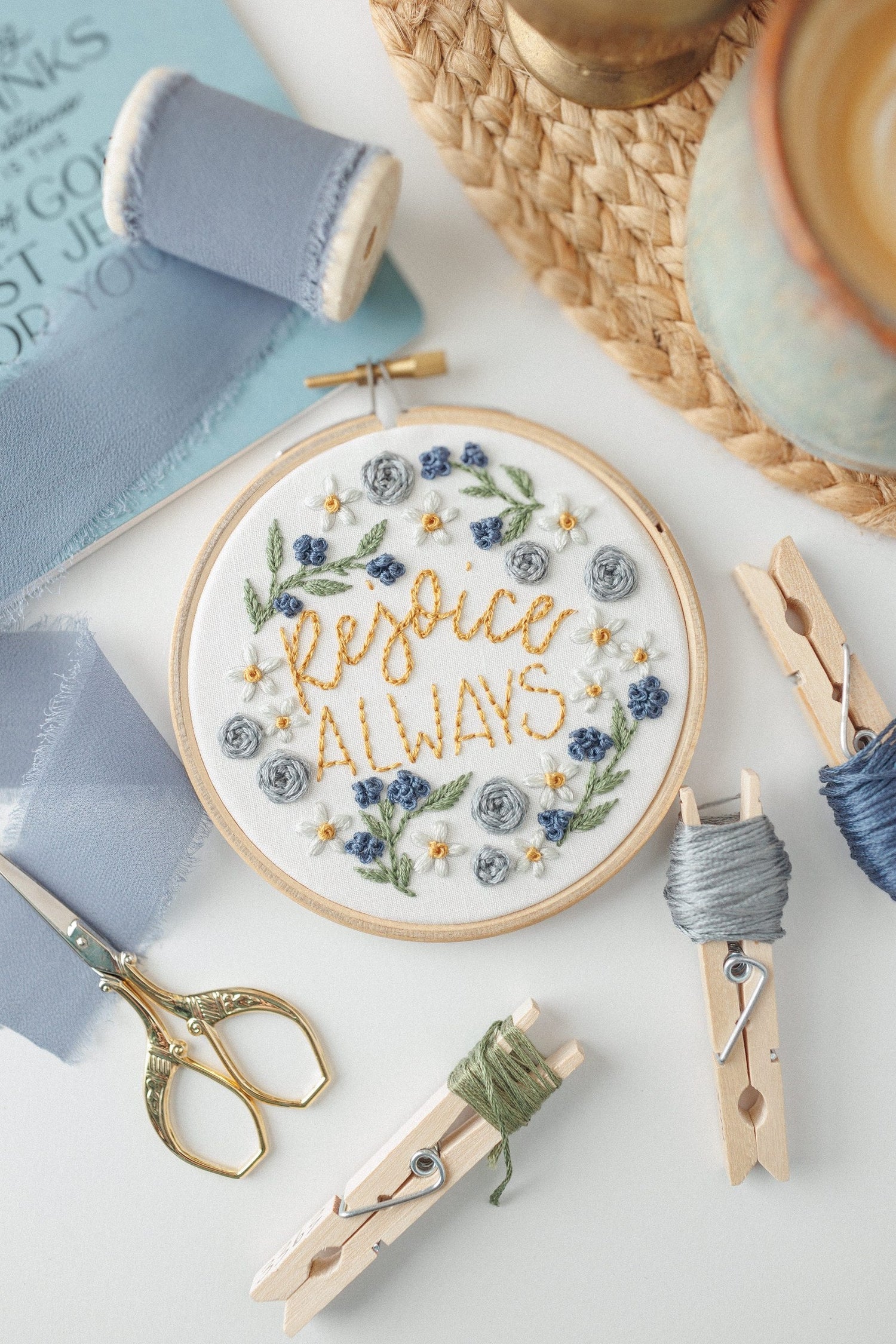 Rejoice Always embroidery hoop with blue ribbon and floss