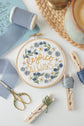 Rejoice Always embroidery hoop with blue ribbon and floss