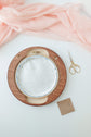 Pre-cut felt backing being fitted into a wooden hoop frame