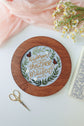 Finished Proverbs 31 piece displayed in a walnut hoop frame