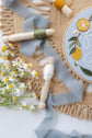 Close-up of the stitched lemons and daisies