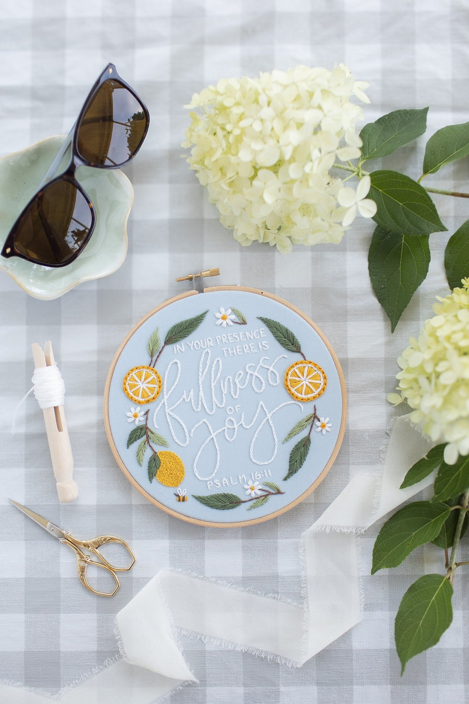Fullness of Joy hoop on a gingham picnic blanket with hydrangea