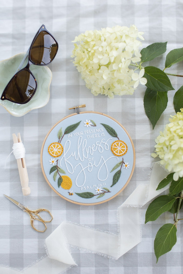 Fullness of Joy hoop on a gingham picnic blanket with hydrangea