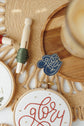 Close-up of the stitched Glory Christmas ornament in red