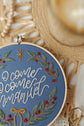 Finished O Come O Come Emmanuel hoop styled with wood beads and sheet music