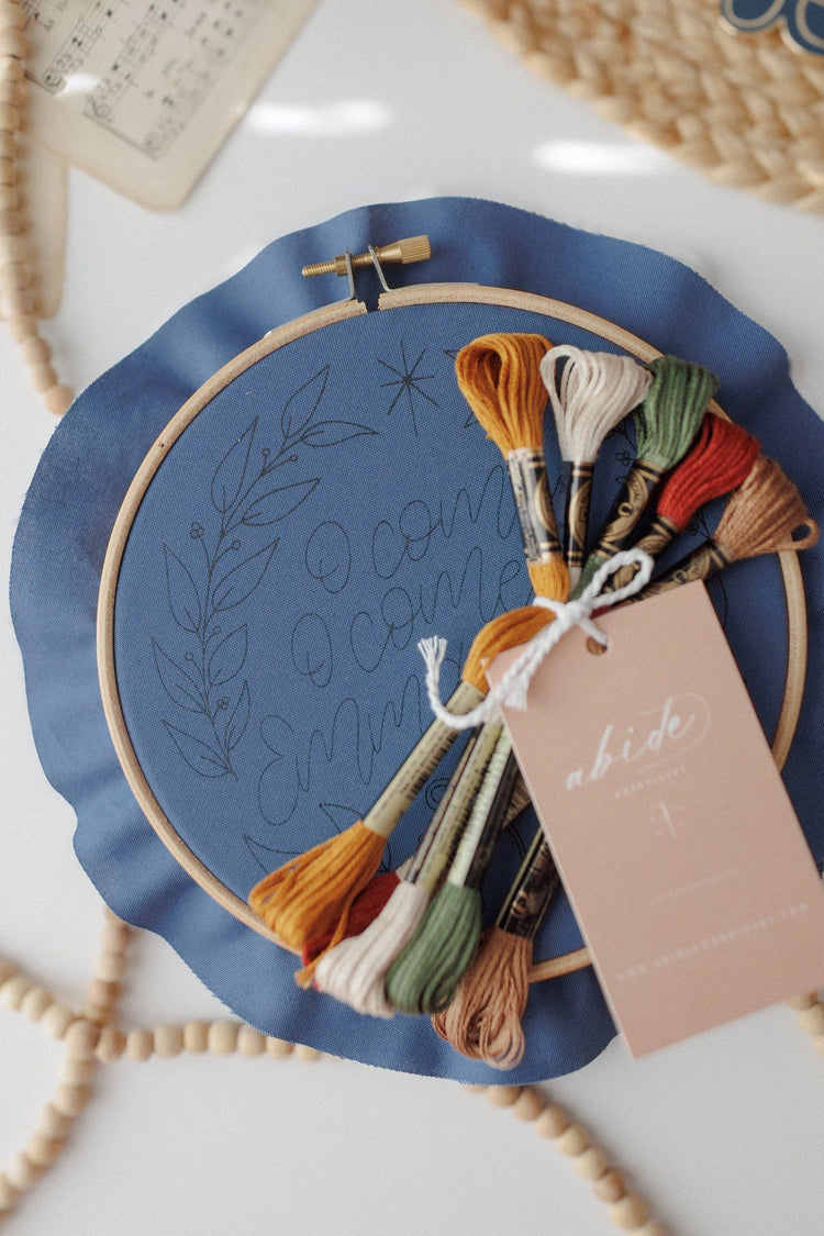 Kit contents — pre-printed navy fabric, embroidery floss and gift tag