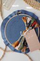 Kit contents — pre-printed navy fabric, embroidery floss and gift tag