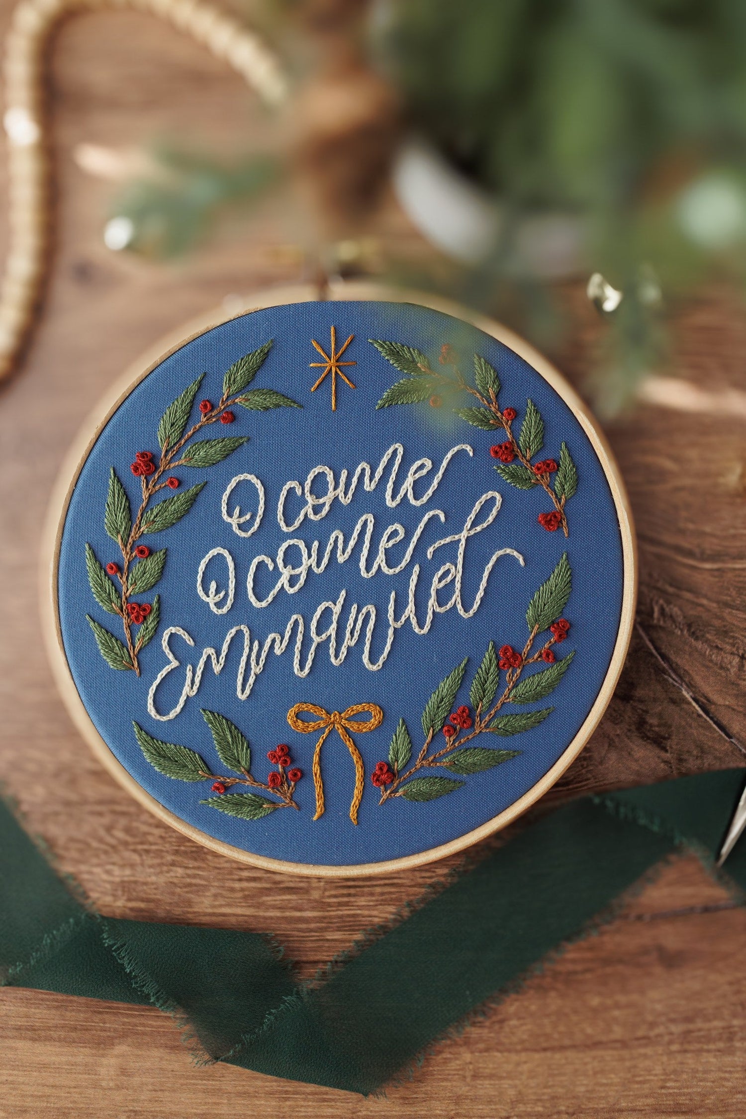 Advent embroidery hoop on dark wood with green velvet ribbon