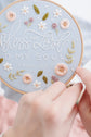Hands stitching the Bless the Lord O My Soul design in progress