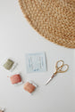 DMC embroidery needle pack with floss bobbins and gold scissors