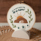 Finished embroidery hoop displayed on the wooden stand