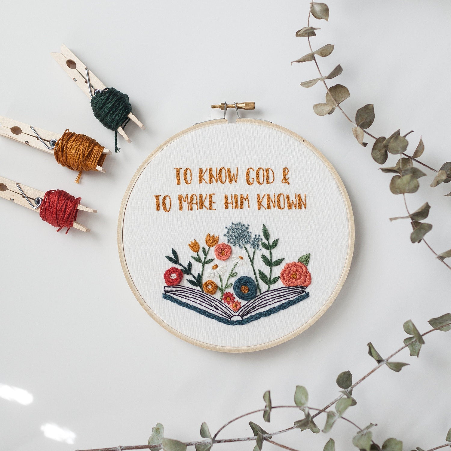 To Know God and Make Him Known embroidery hoop with floss and eucalyptus