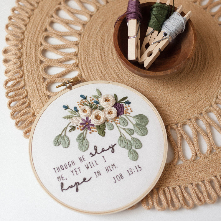 Though He Slay Me, Yet Will I Hope in Him — Job 13:15 floral embroidery hoop on a jute placemat